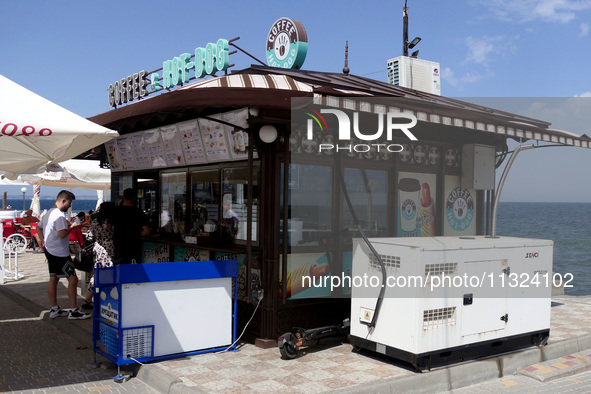 A generator is being installed outside a coffee shop at the seaside in Odesa, Ukraine, on June 11, 2024. NO USE RUSSIA. NO USE BELARUS. 