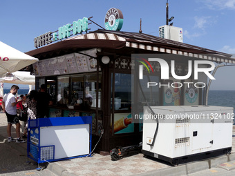 A generator is being installed outside a coffee shop at the seaside in Odesa, Ukraine, on June 11, 2024. NO USE RUSSIA. NO USE BELARUS. (