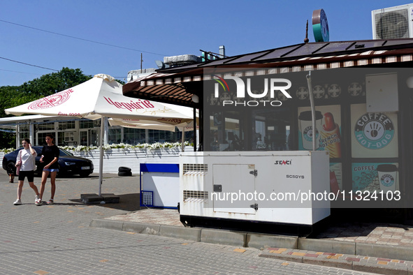 A generator is being installed outside a coffee shop at the seaside in Odesa, Ukraine, on June 11, 2024. NO USE RUSSIA. NO USE BELARUS. 