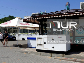 A generator is being installed outside a coffee shop at the seaside in Odesa, Ukraine, on June 11, 2024. NO USE RUSSIA. NO USE BELARUS. (