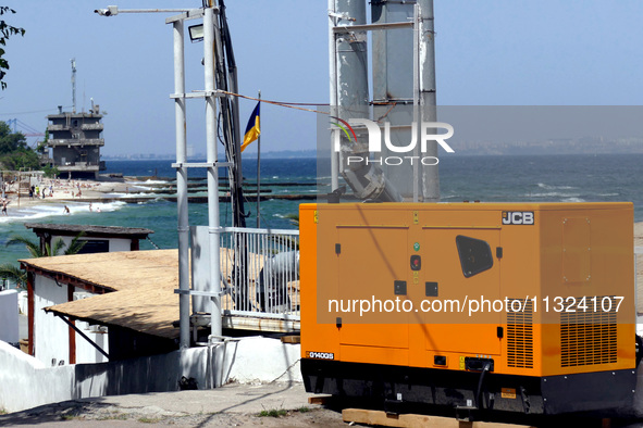 A generator is powering a cafe at the seaside during rolling blackouts in Odesa, Ukraine, on June 11, 2024. NO USE RUSSIA. NO USE BELARUS. 