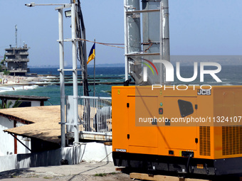 A generator is powering a cafe at the seaside during rolling blackouts in Odesa, Ukraine, on June 11, 2024. NO USE RUSSIA. NO USE BELARUS. (