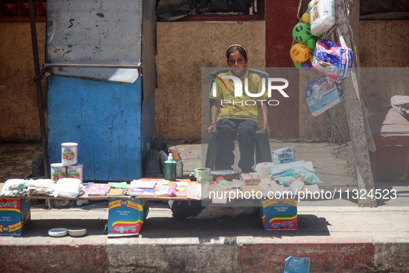 A displaced girl is selling toys and waiting for customers on a street next to Al-Aqsa Martyrs Hospital in Deir el-Balah, in the central Gaz...