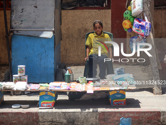 A displaced girl is selling toys and waiting for customers on a street next to Al-Aqsa Martyrs Hospital in Deir el-Balah, in the central Gaz...