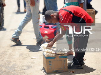 A displaced boy is selling popcorn and waiting for customers on a street next to Al-Aqsa Martyrs Hospital in Deir el-Balah, in the central G...