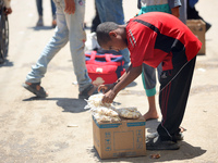 A displaced boy is selling popcorn and waiting for customers on a street next to Al-Aqsa Martyrs Hospital in Deir el-Balah, in the central G...