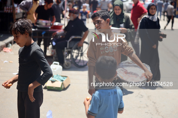 A displaced boy is selling sweets and waiting for customers on a street next to Al-Aqsa Martyrs Hospital in Deir el-Balah, in the central Ga...