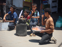 A displaced boy is selling lupin beans and waiting for customers on a street next to Al-Aqsa Martyrs Hospital in Deir el-Balah, in the centr...