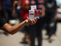 A displaced man is selling cigarettes on a street next to Al-Aqsa Martyrs Hospital in Deir el-Balah, in the central Gaza Strip, on June 12,...