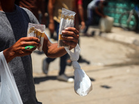 A displaced man is selling hand-rolled cigarettes on a street next to Al-Aqsa Martyrs Hospital in Deir el-Balah, in the central Gaza Strip,...