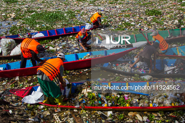 Joint officers are cleaning up plastic waste from the heavily polluted Citarum River in Batujajar, Bandung, West Java, Indonesia, on June 12...