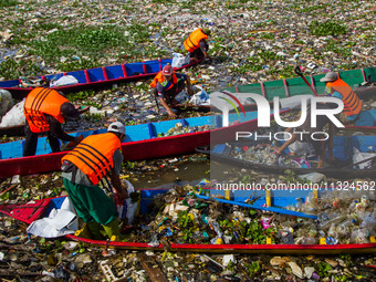 Joint officers are cleaning up plastic waste from the heavily polluted Citarum River in Batujajar, Bandung, West Java, Indonesia, on June 12...