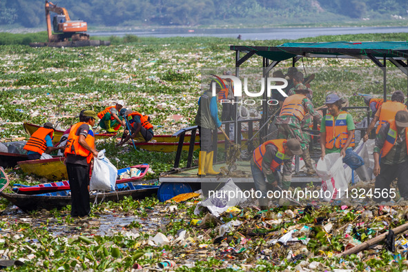 Joint officers are cleaning up plastic waste from the heavily polluted Citarum River in Batujajar, Bandung, West Java, Indonesia, on June 12...