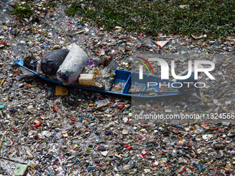 Residents on boats are collecting recyclable plastics from the heavily polluted Citarum River in Batujajar, Bandung, West Java, Indonesia, o...