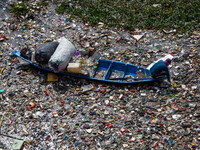 Residents on boats are collecting recyclable plastics from the heavily polluted Citarum River in Batujajar, Bandung, West Java, Indonesia, o...