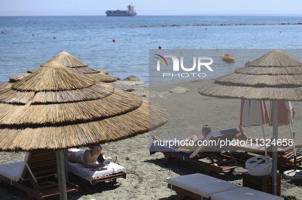 Women relax on a public beach on a hot sunny day in the Mediterranean port of Limassol. Cyprus, Wednesday, June 12, 2024. This summer is exp...