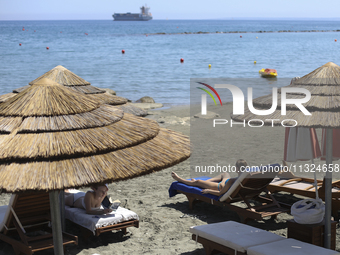 Women relax on a public beach on a hot sunny day in the Mediterranean port of Limassol. Cyprus, Wednesday, June 12, 2024. This summer is exp...