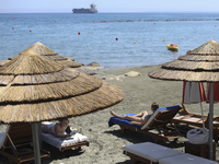 Women relax on a public beach on a hot sunny day in the Mediterranean port of Limassol. Cyprus, Wednesday, June 12, 2024. This summer is exp...