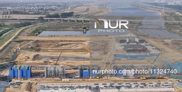 Workers are working on the construction of the second phase of the Huaihe River estuary waterway project in the second river hub section in...