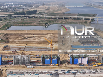 Workers are working on the construction of the second phase of the Huaihe River estuary waterway project in the second river hub section in...