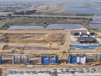 Workers are working on the construction of the second phase of the Huaihe River estuary waterway project in the second river hub section in...