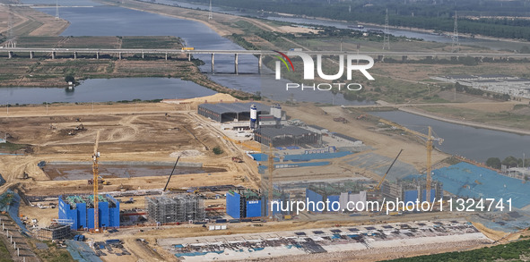 Workers are working on the construction of the second phase of the Huaihe River estuary waterway project in the second river hub section in...