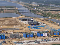 Workers are working on the construction of the second phase of the Huaihe River estuary waterway project in the second river hub section in...