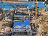 Workers are working on the construction of the second phase of the Huaihe River estuary waterway project in the second river hub section in...