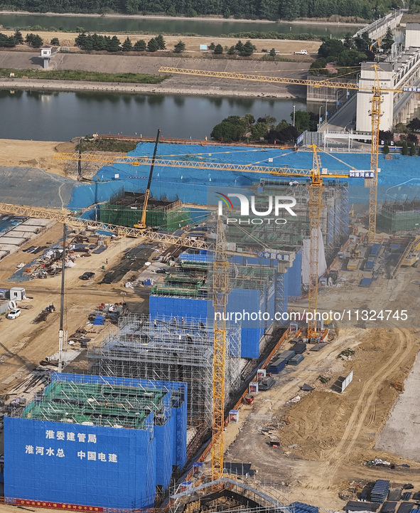 Workers are working on the construction of the second phase of the Huaihe River estuary waterway project in the second river hub section in...