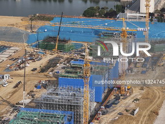 Workers are working on the construction of the second phase of the Huaihe River estuary waterway project in the second river hub section in...