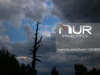 Dark clouds are hovering above residential houses during a windy and rainy day in Srinagar, India, on June 12, 2024. (