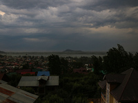 Dark clouds are hovering above residential houses during a windy and rainy day in Srinagar, India, on June 12, 2024. (