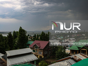 Dark clouds are hovering above residential houses during a windy and rainy day in Srinagar, India, on June 12, 2024. (