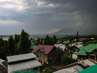 Dark clouds are hovering above residential houses during a windy and rainy day in Srinagar, India, on June 12, 2024. (