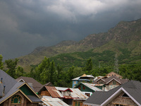 Dark clouds are hovering above residential houses during a windy and rainy day in Srinagar, India, on June 12, 2024. (