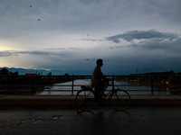 A man is riding his bicycle after light rainfall in Sopore, Jammu and Kashmir, India, on June 12, 2024 (