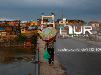 A man is walking as he is holding an umbrella after light rainfall in Sopore, Jammu and Kashmir, India, on June 12, 2024 (