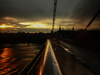 People are walking on a bridge during sunset after light rainfall in Sopore, Jammu and Kashmir, India, on June 12, 2024 (