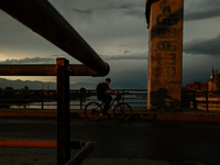 A boy is riding a bicycle during sunset after rainfall in Sopore, Jammu and Kashmir, India, on June 12, 2024 (