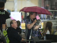 People shelter at a restaurant from a sudden downpour in Warsaw, Poland on 02 June, 2024. (