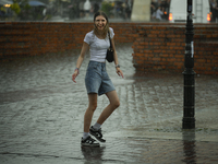 People are seen sheltering from a sudden downpour in Warsaw, Poland on 02 June, 2024. (