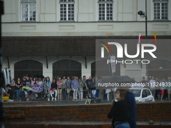 People are seen sheltering from a sudden downpour in Warsaw, Poland on 02 June, 2024. (