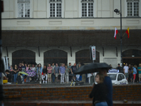 People are seen sheltering from a sudden downpour in Warsaw, Poland on 02 June, 2024. (