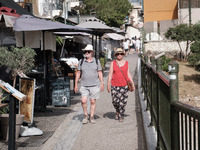 Tourists are wearing hats near Monastiraki Square during a heatwave in Athens, Greece, on June 12, 2024. Many of the country's schools are r...