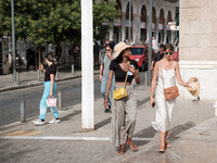 A woman is wearing a hat to protect from the sun near Monastiraki Square during a heatwave in Athens, Greece, on June 12, 2024. Many of the...