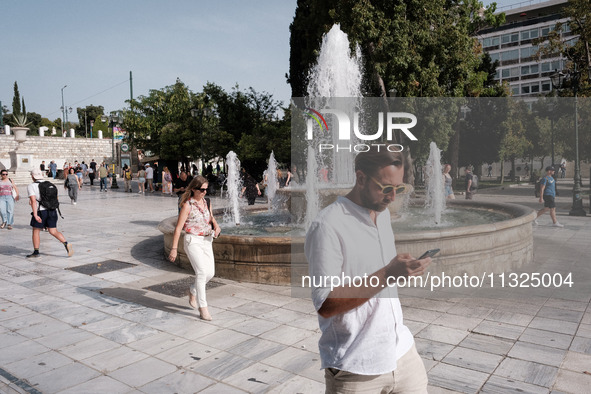 Tourists are wearing sunglasses to protect from the sun at Syntagma Square during a heatwave in Athens, Greece, on June 12, 2024. Many of th...