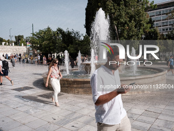 Tourists are wearing sunglasses to protect from the sun at Syntagma Square during a heatwave in Athens, Greece, on June 12, 2024. Many of th...