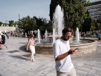 Tourists are wearing sunglasses to protect from the sun at Syntagma Square during a heatwave in Athens, Greece, on June 12, 2024. Many of th...