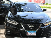 A vehicle is being damaged by bullet holes in the KFC parking lot. Three people are being shot in Chicago, Illinois, United States, on June...