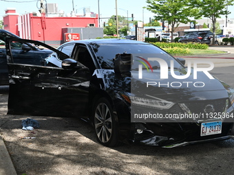 A vehicle is being damaged by bullet holes in the KFC parking lot. Three people are being shot in Chicago, Illinois, United States, on June...